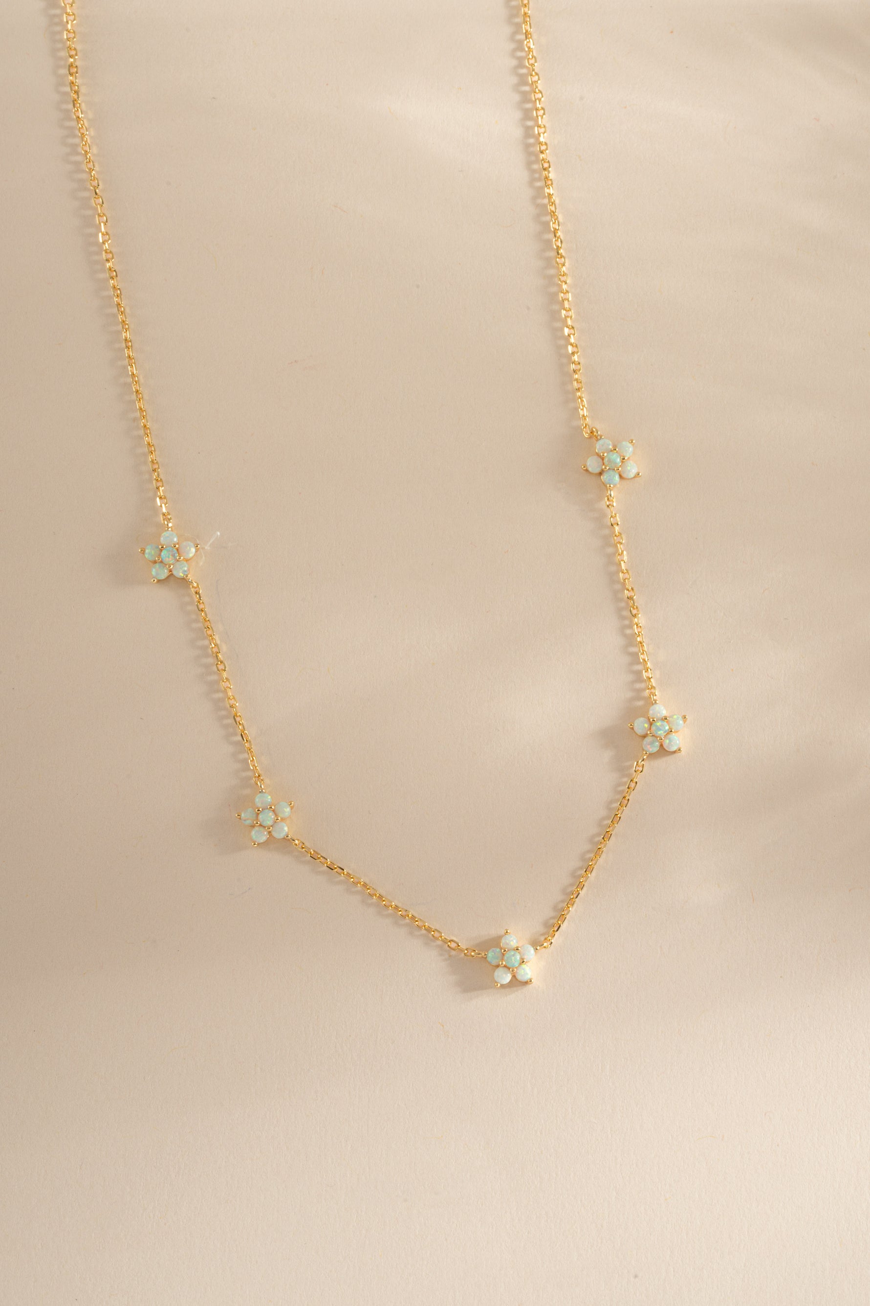 Gold Opal Flower Charm Necklace from Sami Jewels, featuring a delicate floral pendant on a fine chain.