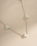 Sterling silver Opal Flower Charm Necklace from Sami Jewels featuring a delicate floral pendant with vibrant opal stone.