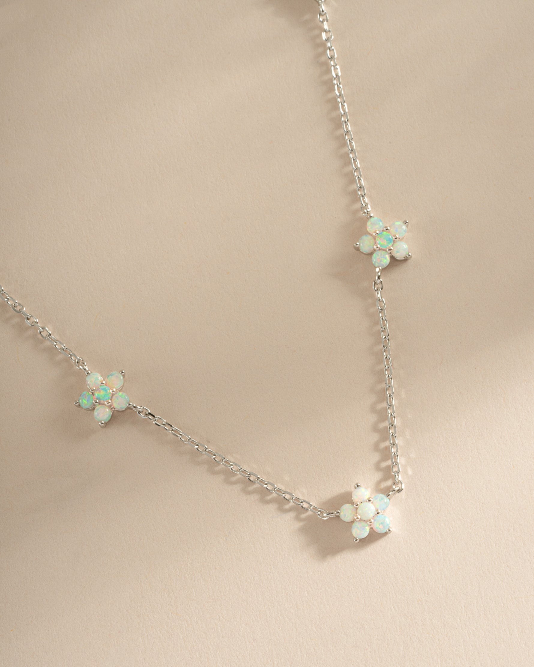 Sterling silver Opal Flower Charm Necklace from Sami Jewels featuring a delicate floral pendant with vibrant opal stone.