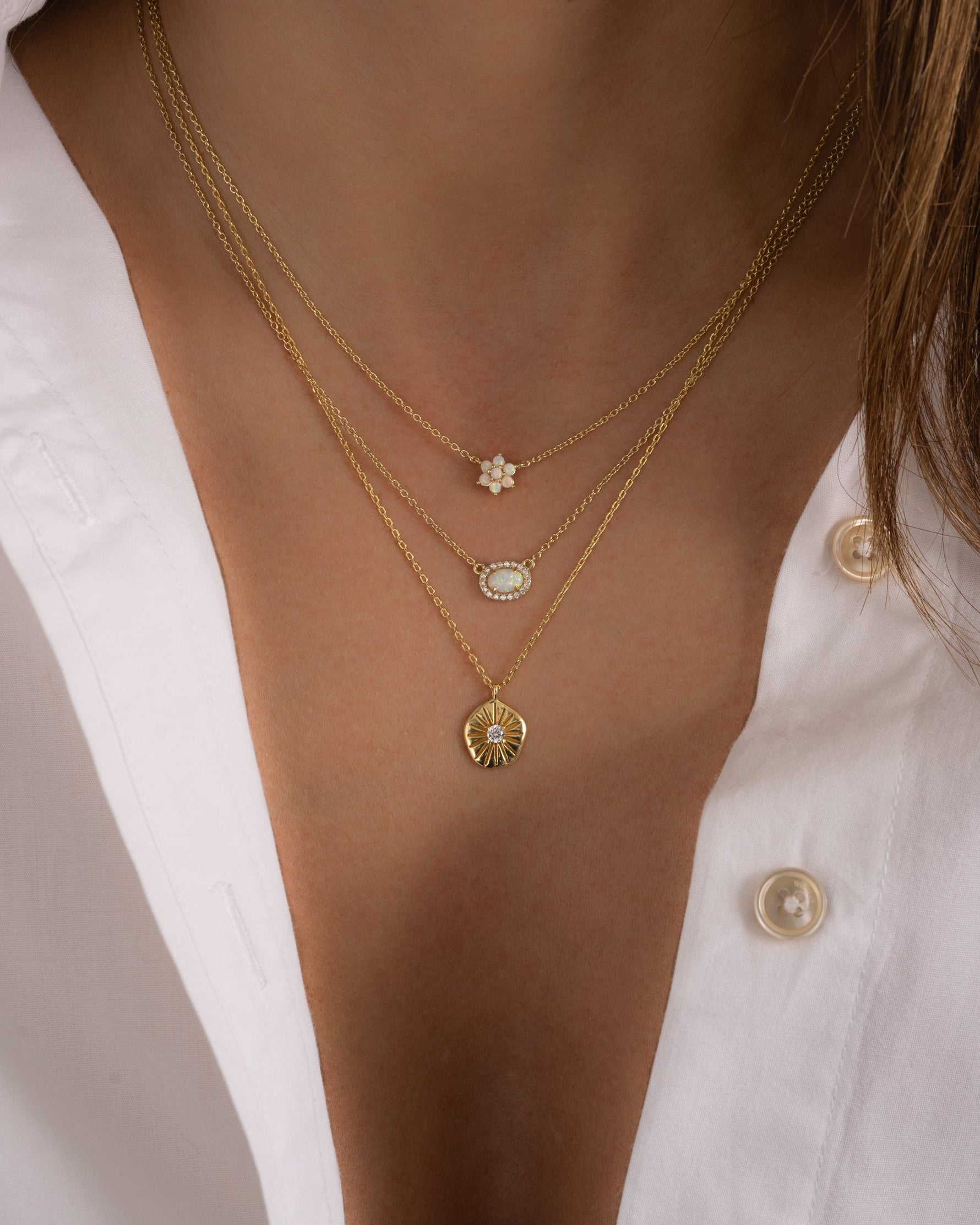 Gold opal flower necklace by Sami Jewels worn on a model, featuring a delicate floral design and vibrant opal centerpiece.