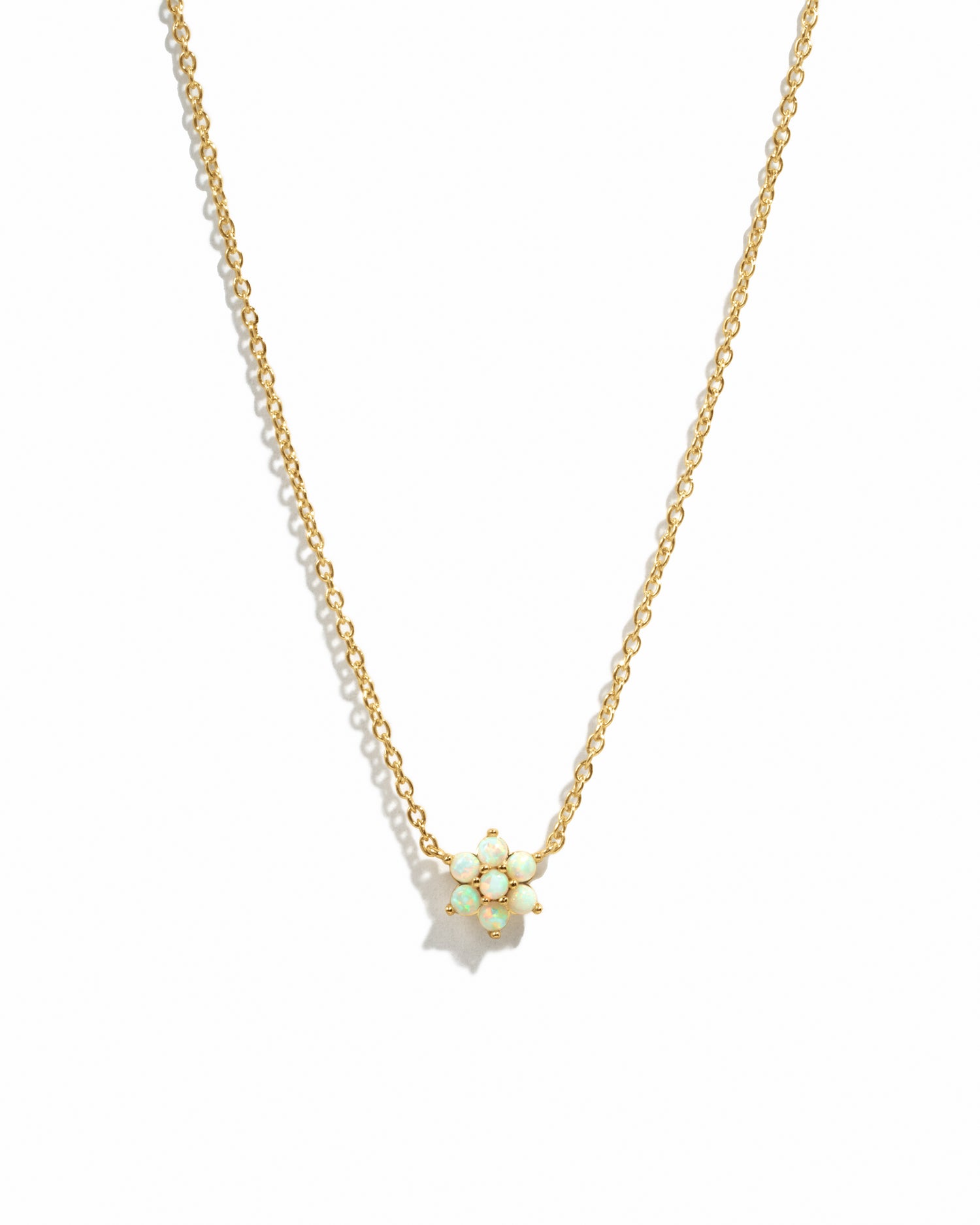 Gold Opal Flower Necklace by Sami Jewels featuring a delicate floral design on a white background.