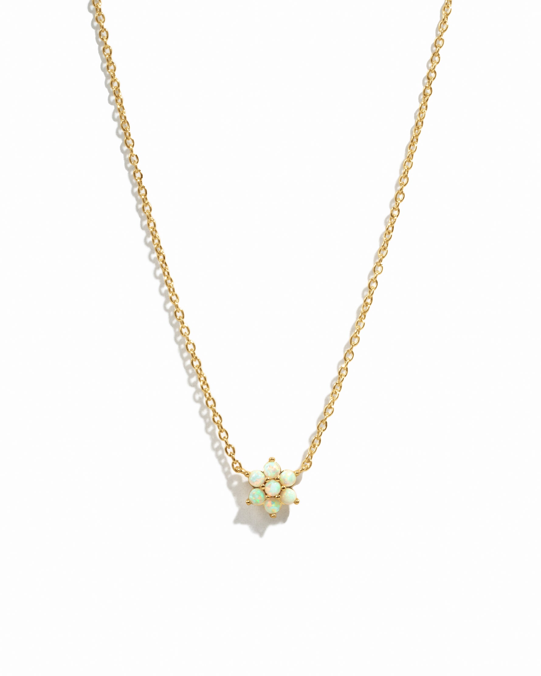 Gold Opal Flower Necklace by Sami Jewels featuring a delicate floral design on a white background.