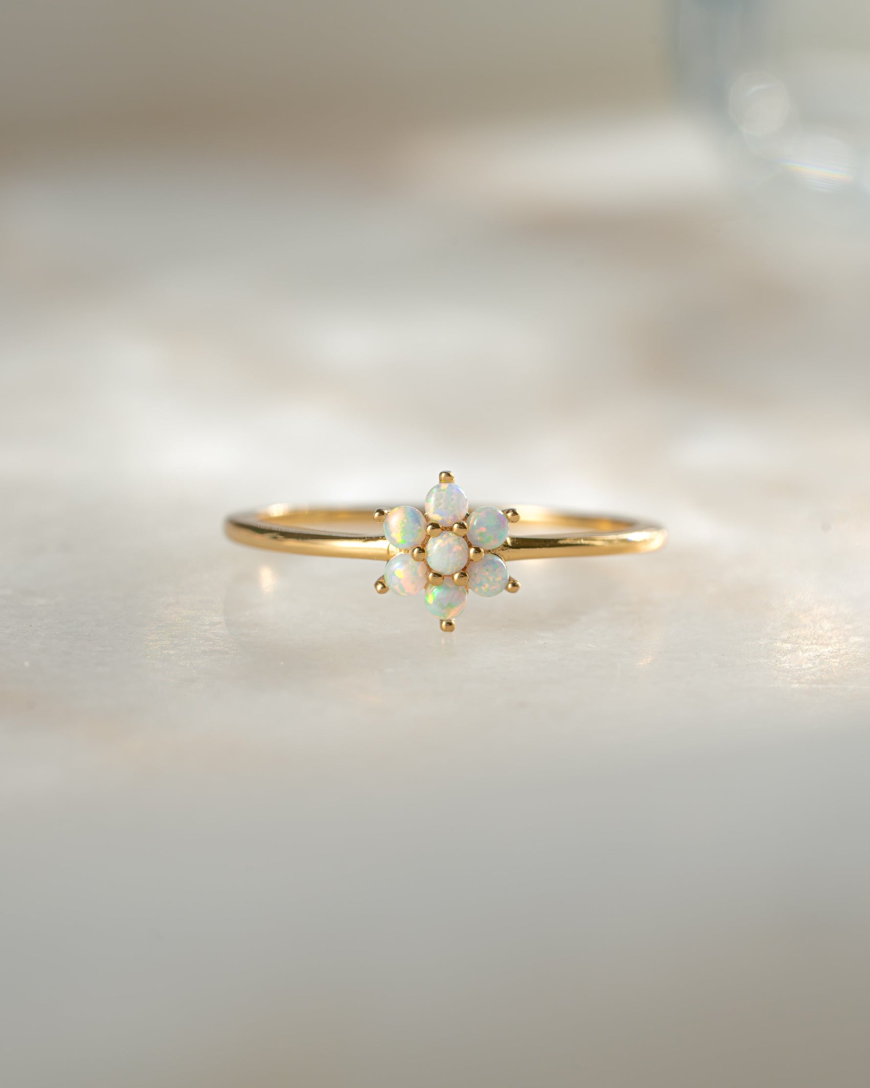 Close-up of Samijewels-527 Opal Flower Ring featuring a vibrant opal flower design with gold band and detailed stone setting.