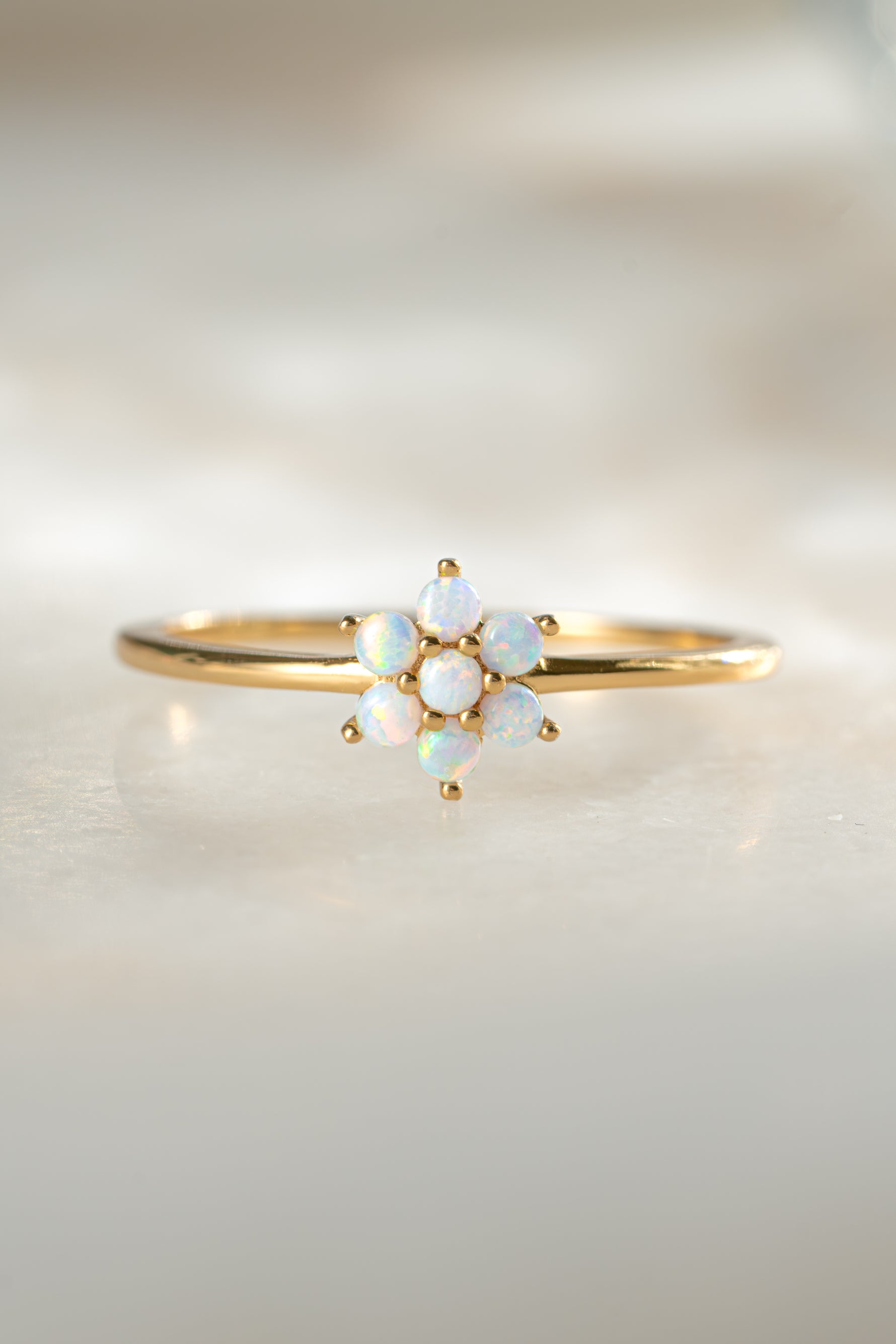 Close-up of Samijewels-527 opal flower ring featuring a vibrant opal gemstone set in a gold ring.