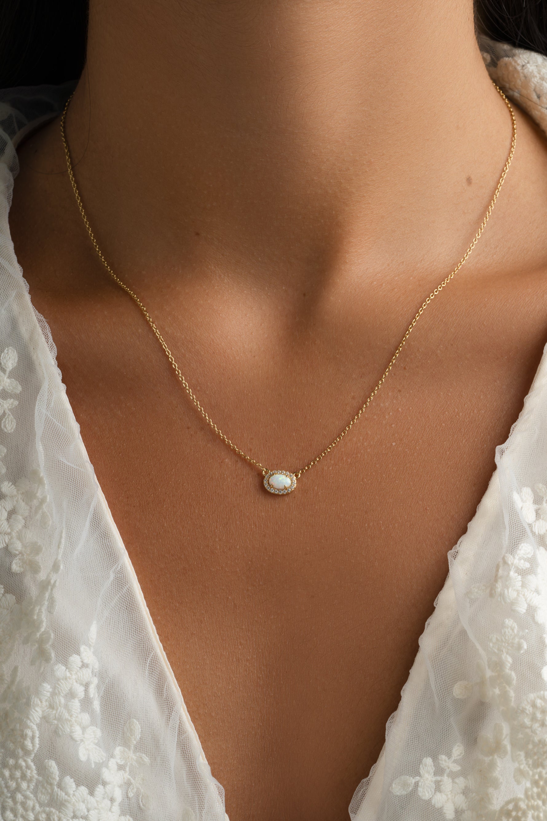 Gold Opal Halo Necklace by Sami Jewels featuring a central opal gemstone surrounded by a delicate halo design.