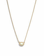 Gold opal halo necklace by Sami Jewels featuring a central opal gemstone with a delicate halo design.