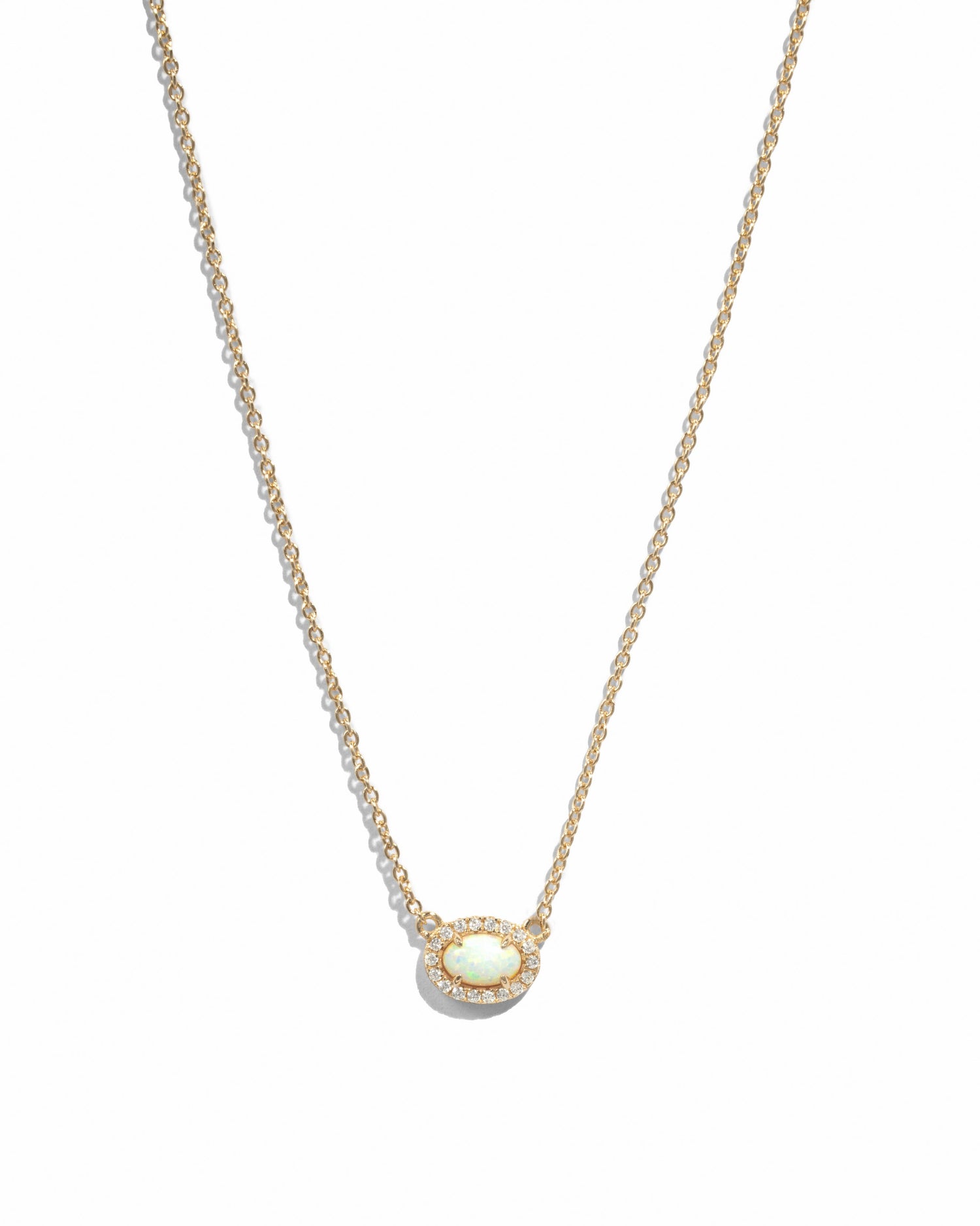 Gold opal halo necklace by Sami Jewels featuring a central opal gemstone with a delicate halo design.