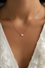 Sami Jewels opal halo necklace with a rose gold chain featuring a central opal gemstone surrounded by a halo setting.