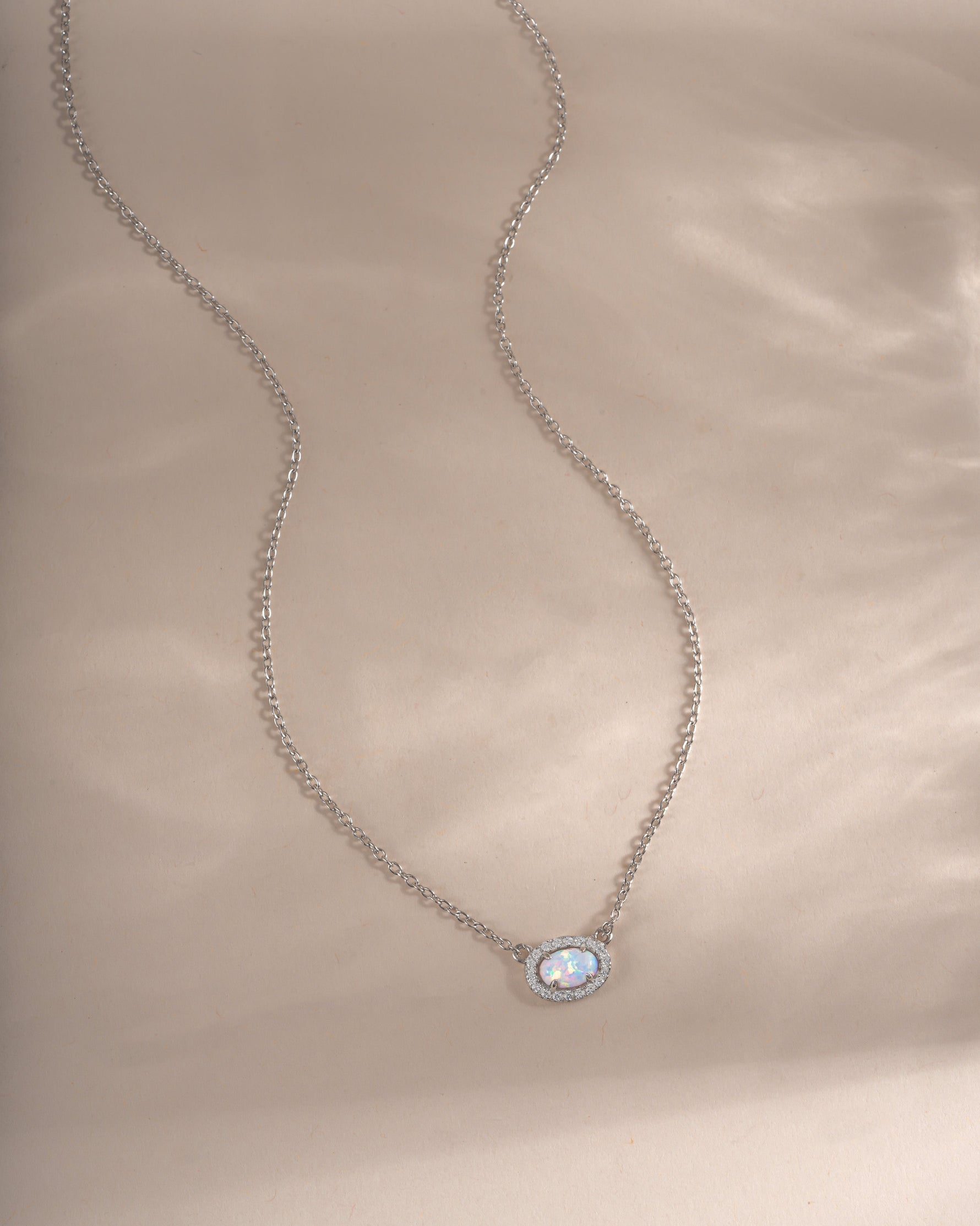 Sterling silver Opal Halo Necklace by Sami Jewels featuring a central opal gemstone surrounded by a halo setting.