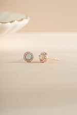 Rose gold Opal Halo Stud Earrings by Sami Jewels, featuring round opal stones surrounded by a halo setting.
