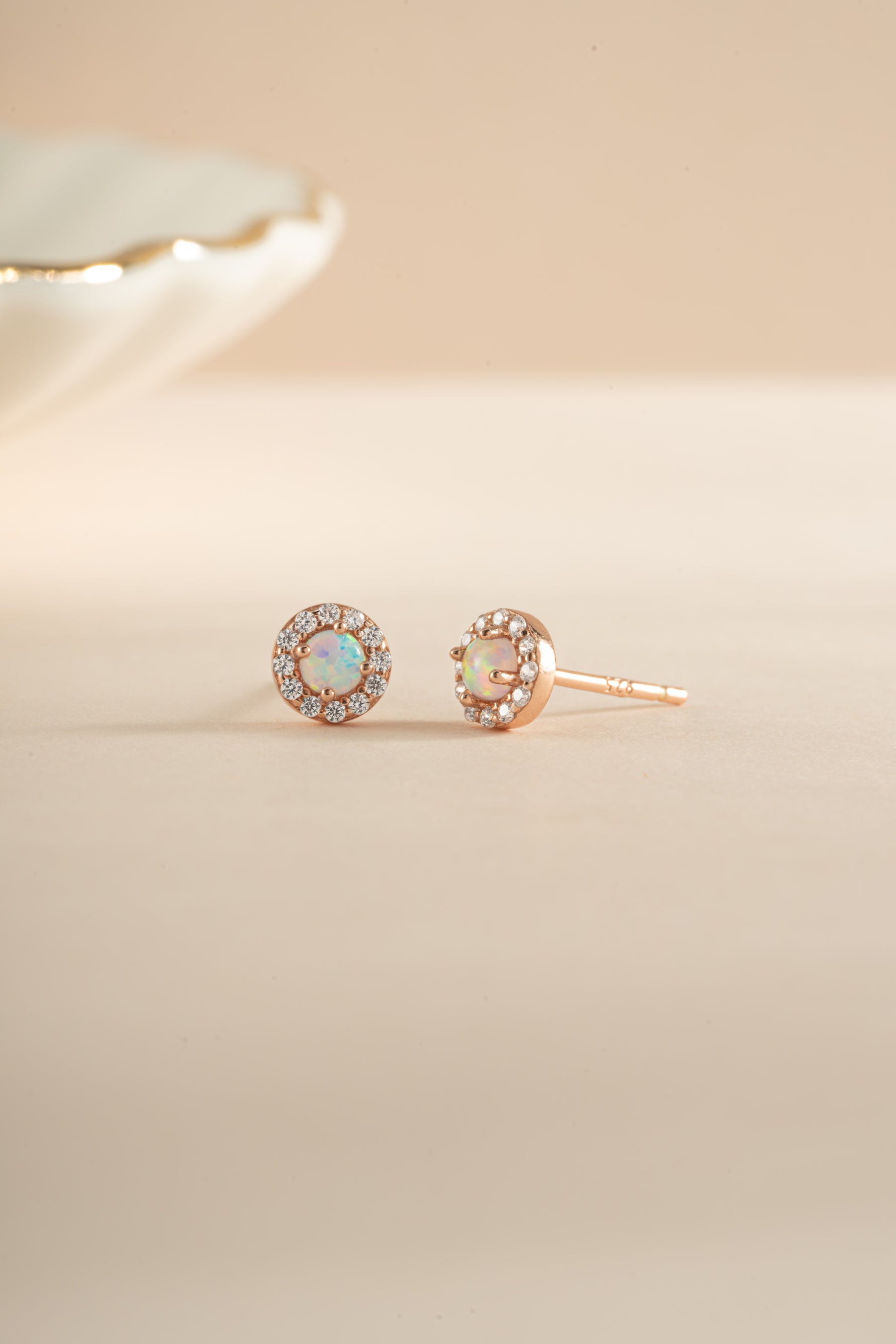 Rose gold Opal Halo Stud Earrings by Sami Jewels, featuring round opal stones surrounded by a halo setting.