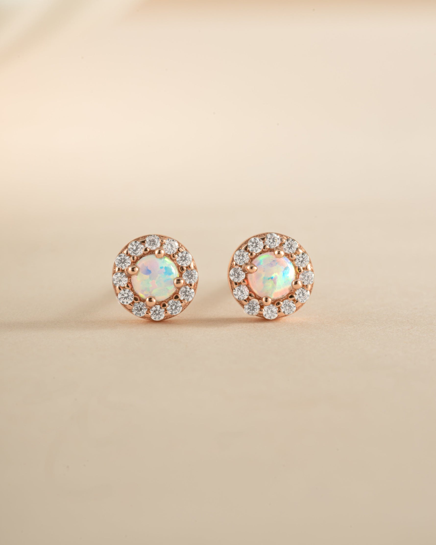 Rose gold Opal Halo Stud Earrings by Sami Jewels featuring sparkling opal stones and a delicate halo design.