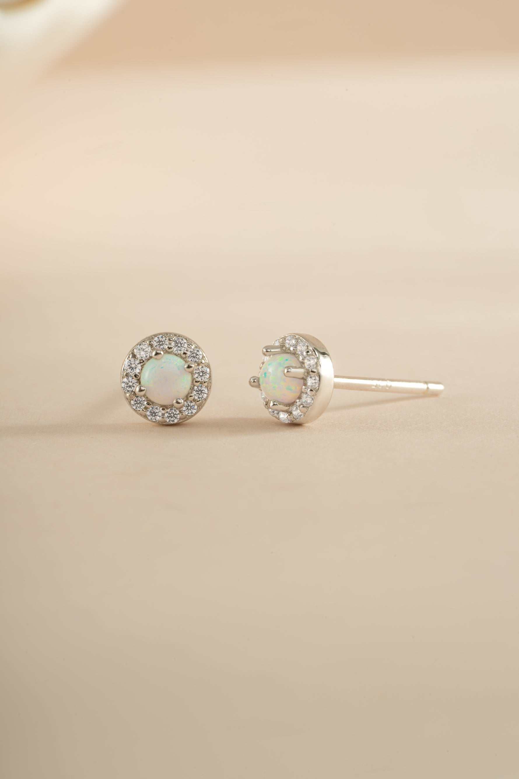 Sterling silver opal halo stud earrings by Sami Jewels featuring sparkling opal gemstones and a classic halo design.