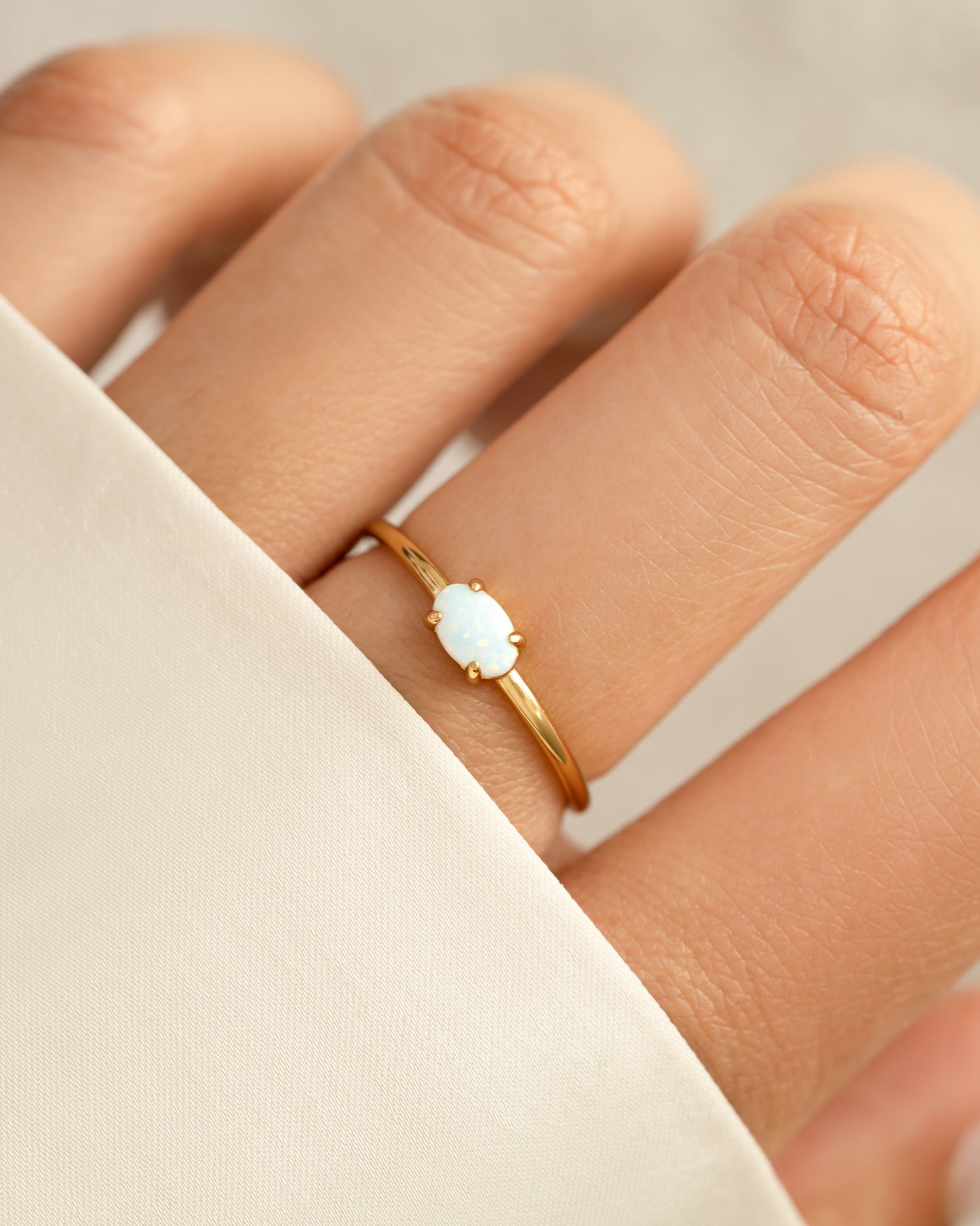 opal oval ring in gold on models hand