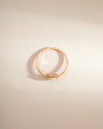 Gold opal halo ring by Sami Jewels, top view showing the vibrant opal gemstone surrounded by a delicate halo design.