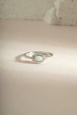 Sterling silver Opal Halo Ring by Sami Jewels featuring a vibrant opal gemstone surrounded by a silver halo design.