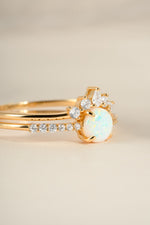 Gold opal ring set with pave accents from Sami Jewels, featuring an elegant angled view of the jewelry.