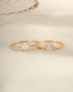 Gold opal ring set with pave accents by Sami Jewels, featuring multiple rings with vibrant opal stones and intricate detailing.