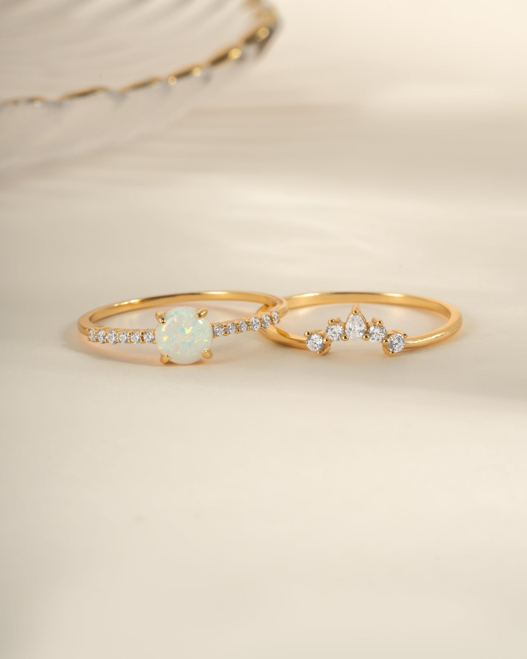 Gold opal ring set with pave accents by Sami Jewels, featuring multiple rings with vibrant opal stones and intricate detailing.