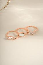 Three Sami Jewels opal rings set in rose gold, displayed from an angled view showcasing the colorful opal stones.