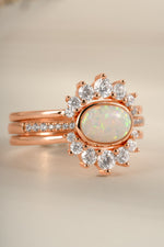 Set of three Sami Jewels opal rings with rose gold bands, featuring colorful opal stones, front view.