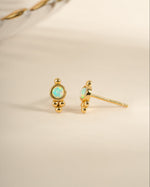 Gold embellished opal stud earrings by Sami Jewels featuring sparkling opal gemstones and delicate gold settings.