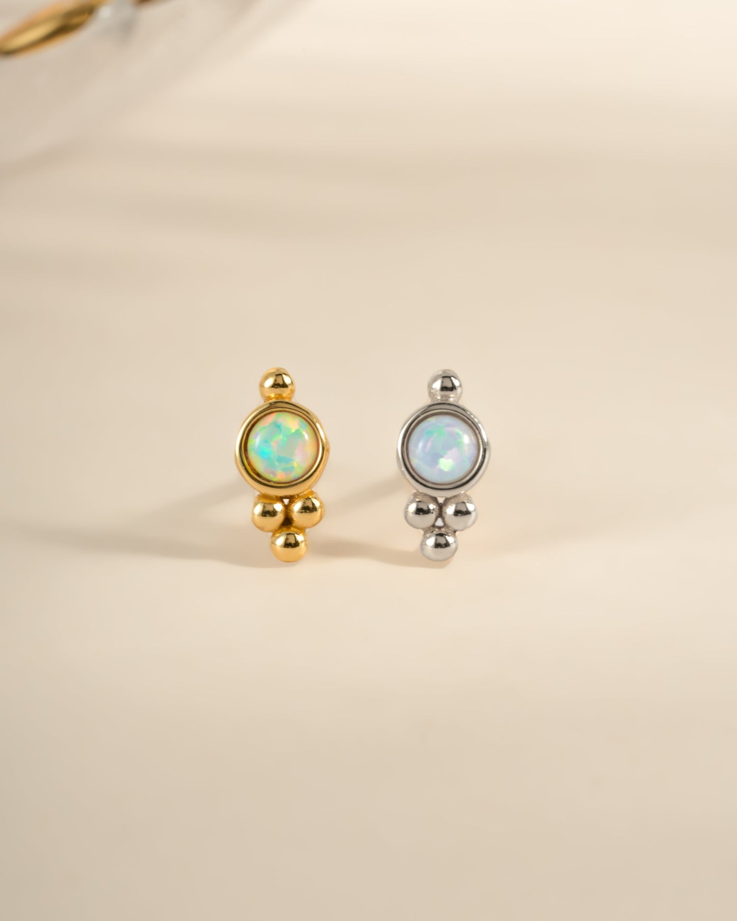 Sami Jewels embellished opal stud earrings with sterling silver and gold accents, showcasing sparkling gemstone details.