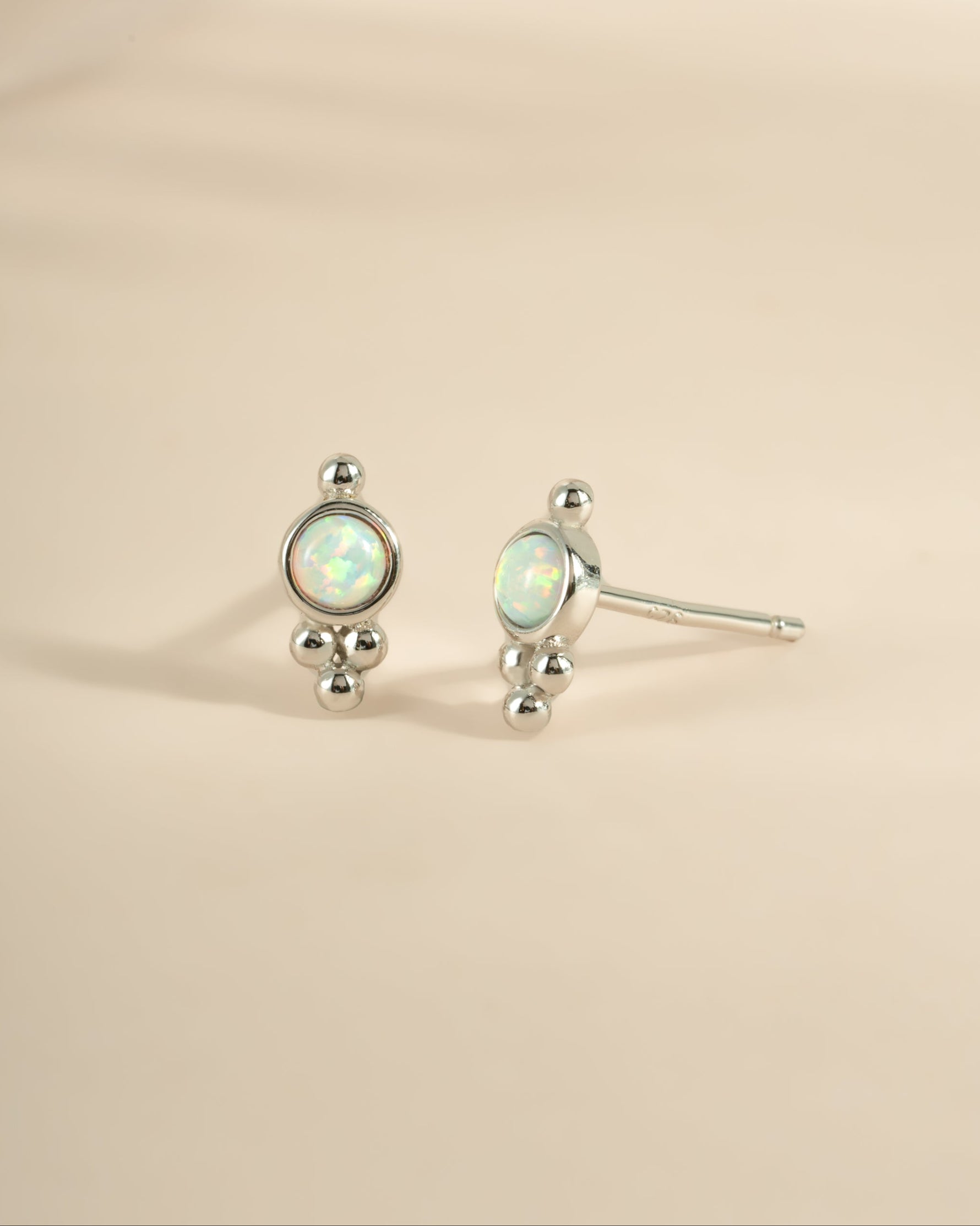 Sterling silver embellished opal stud earrings by Sami Jewels featuring vibrant, iridescent opal stones.