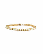 Gold Opal Tennis Bracelet by Sami Jewels featuring a row of white opal stones on a clean white background.