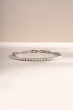 Silver opal tennis bracelet by Sami Jewels featuring a row of shimmering opal gemstones on a sleek bracelet design.