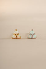 Sami Jewels opal three-stone stud earrings in gold and sterling silver with sparkling gemstones on a white background.