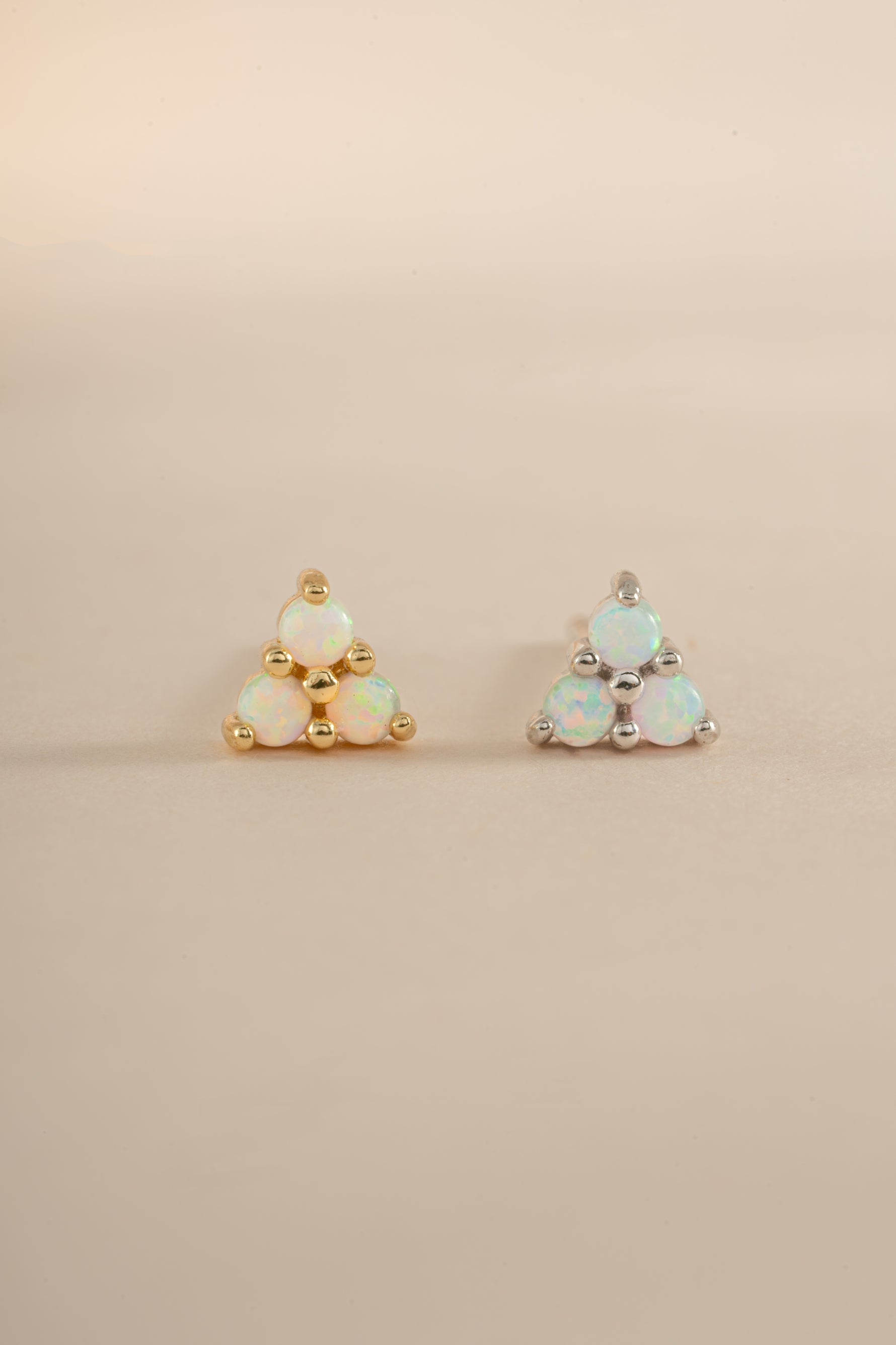 Sami Jewels opal three-stone stud earrings in gold and sterling silver with sparkling gemstones on a white background.