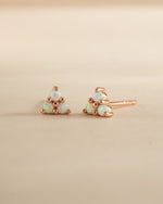 Rose gold Opal Three Stone Stud Earrings by Sami Jewels featuring sparkling opal gemstones in a classic stud design.
