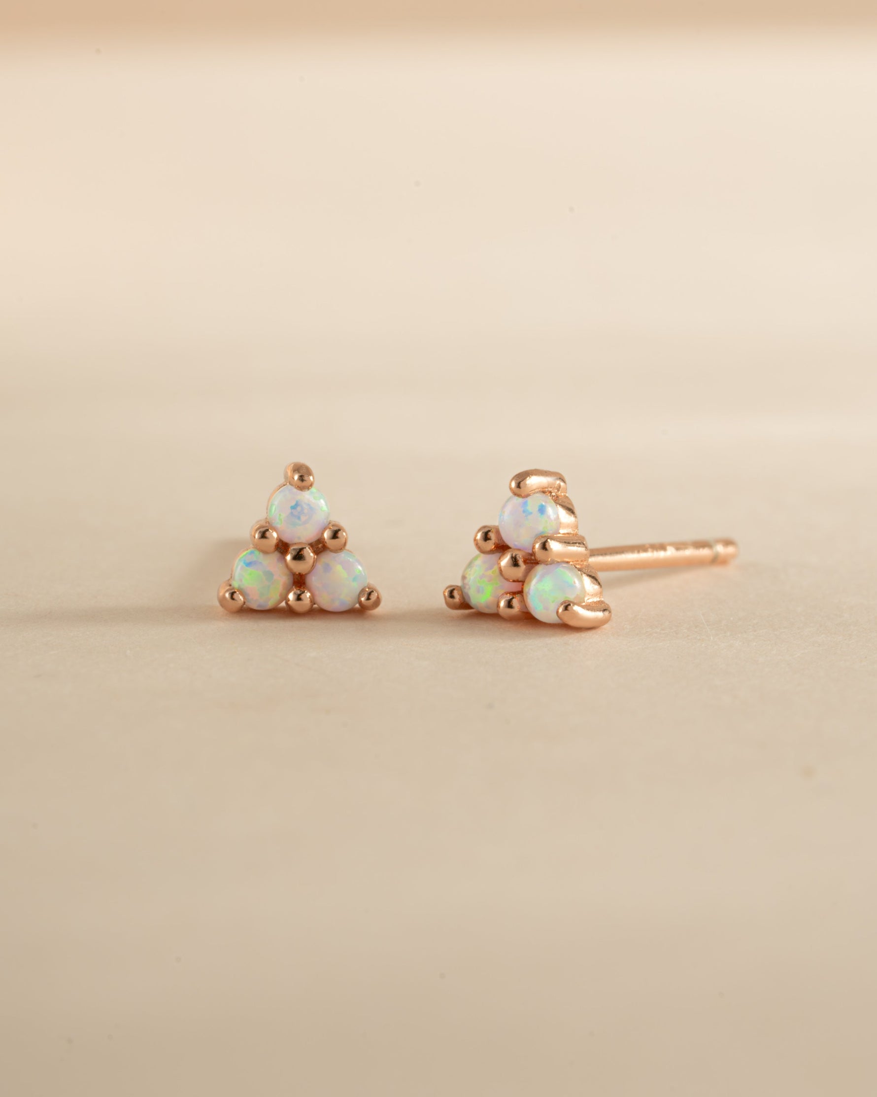 Rose gold Opal Three Stone Stud Earrings by Sami Jewels featuring sparkling opal gemstones in a classic stud design.