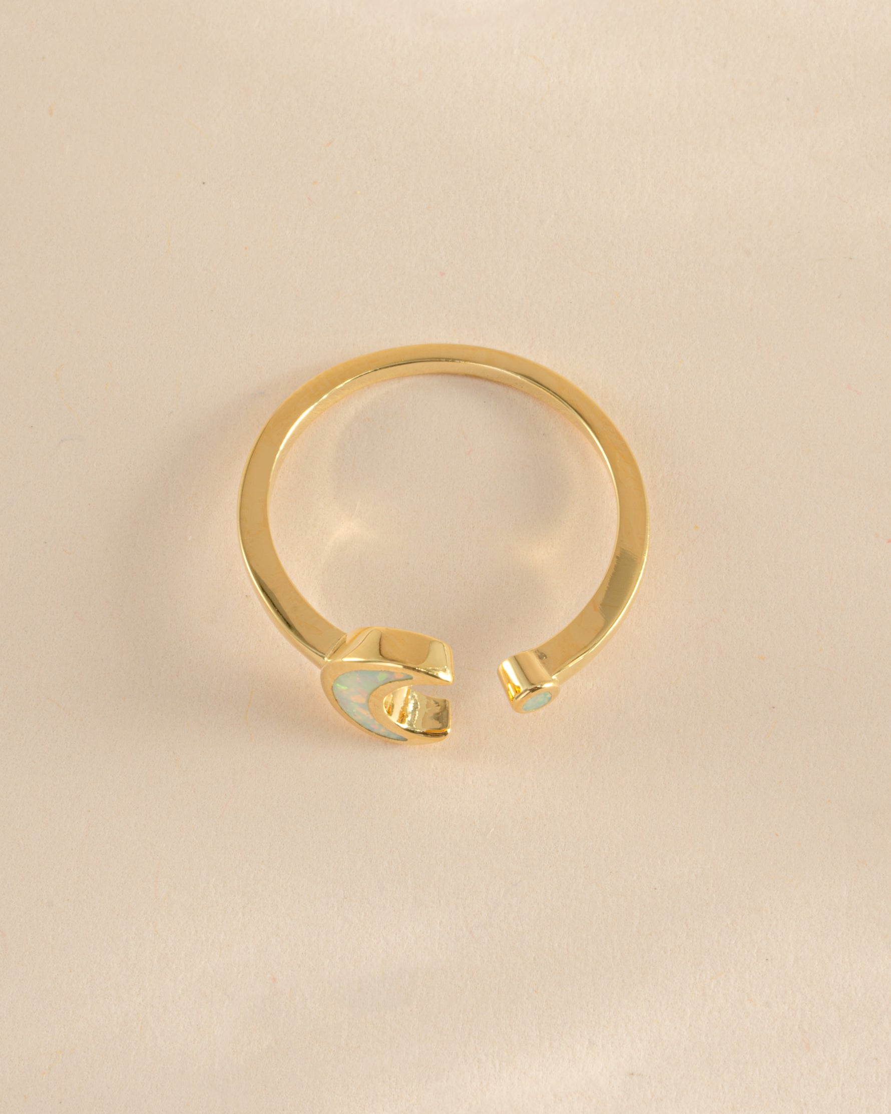 Gold Opal Moon Ring by Sami Jewels featuring an open design and a luminous opal gemstone, viewed from the top.