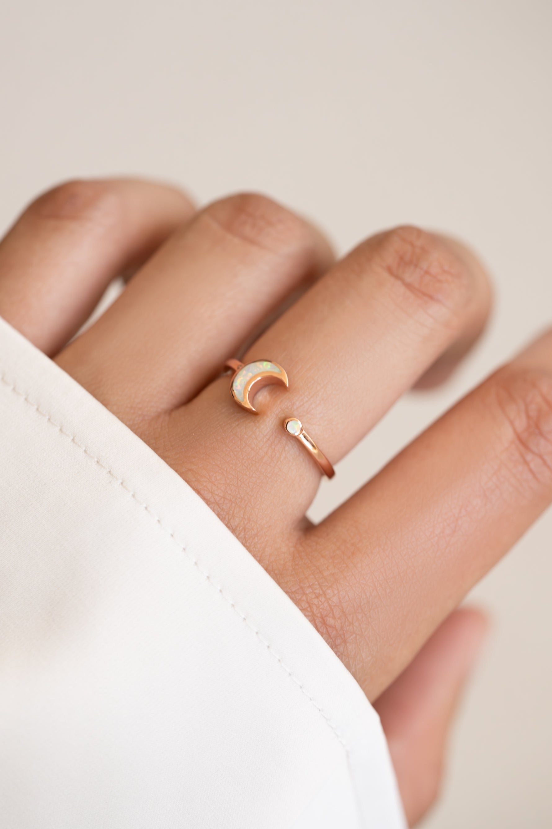 Rose gold Opal Moon ring by Sami Jewels featuring an open design with a luminous opal gemstone.