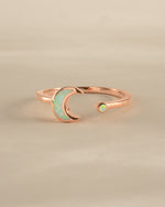 Open opal moon ring in rose gold by Sami Jewels, featuring a delicate moon-shaped design with a glowing opal centerpiece.