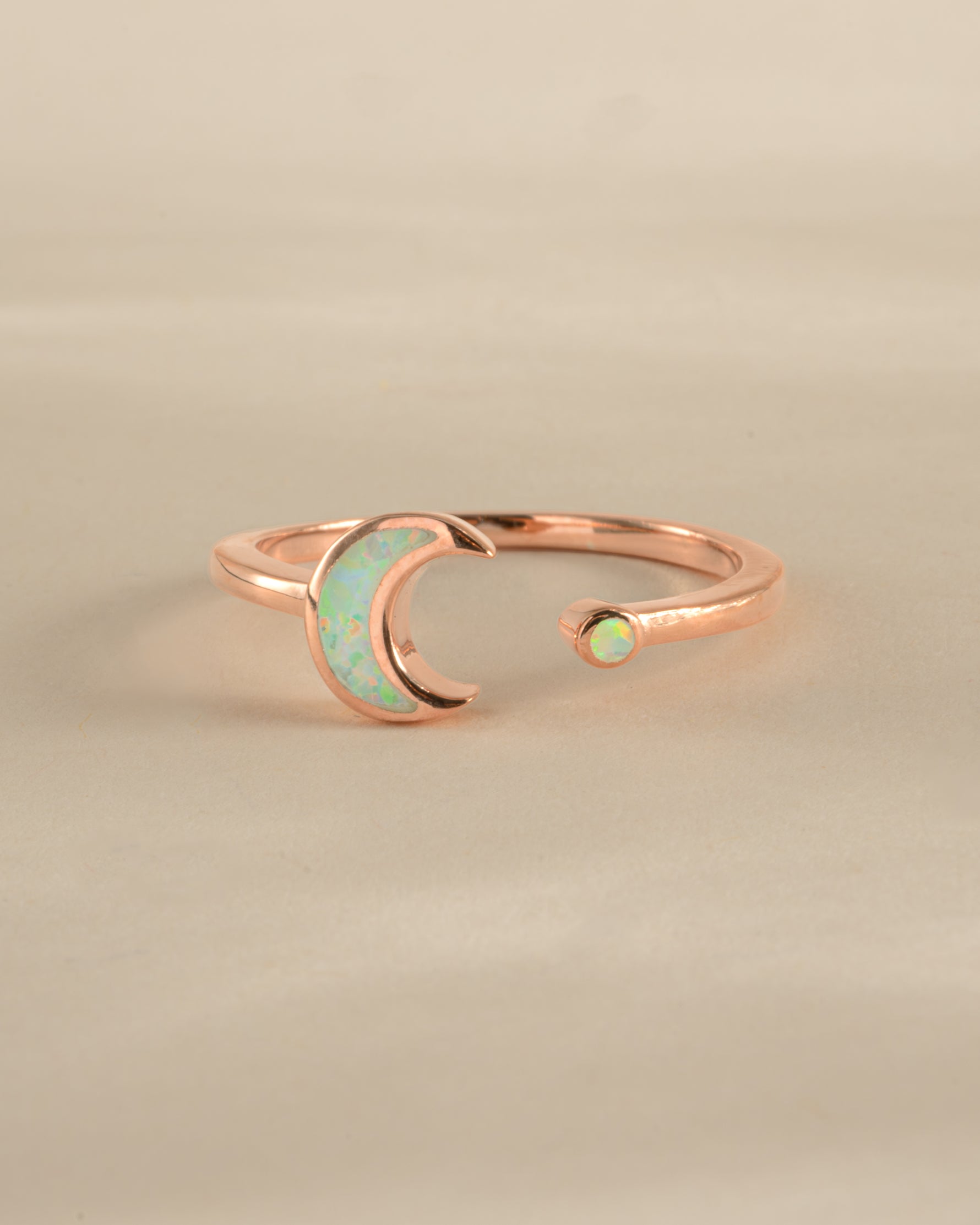 Open opal moon ring in rose gold by Sami Jewels, featuring a delicate moon-shaped design with a glowing opal centerpiece.