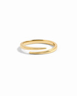 Gold open spiral ring by Sami Jewels, featuring a sleek, minimalist design on a white background.