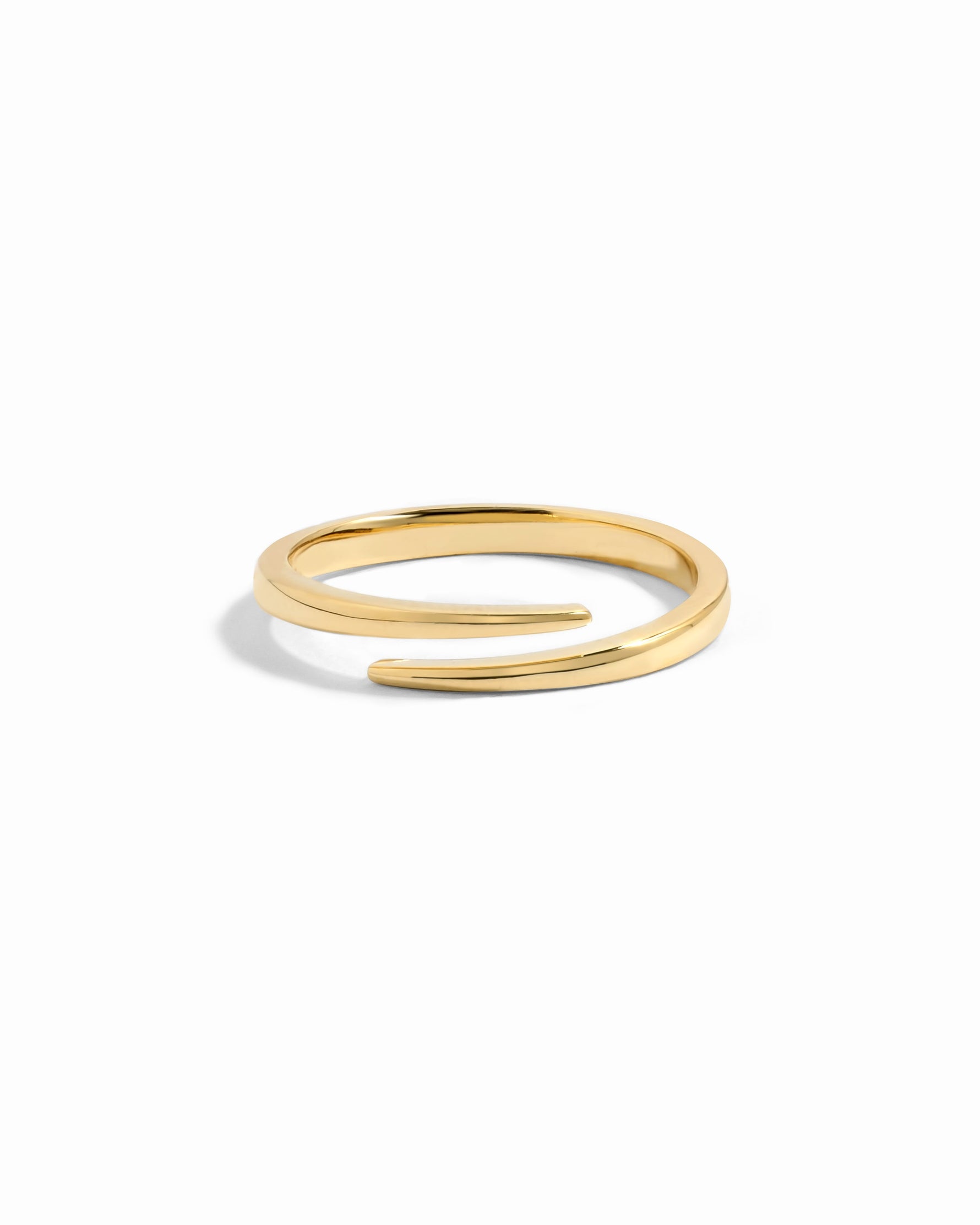 Gold open spiral ring by Sami Jewels, featuring a sleek, minimalist design on a white background.