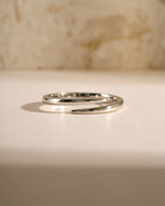 Close-up of a sterling silver open spiral ring by Sami Jewels, showcasing its elegant, curved design and polished finish.