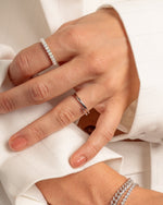 Sterling silver open spiral ring by Sami Jewels, showcasing a sleek, minimalist design with a spiral motif on a plain background.