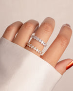 Sami Jewels oval diamond ring with gold and sterling silver band, showcasing a sparkling central oval-cut diamond on a white background.