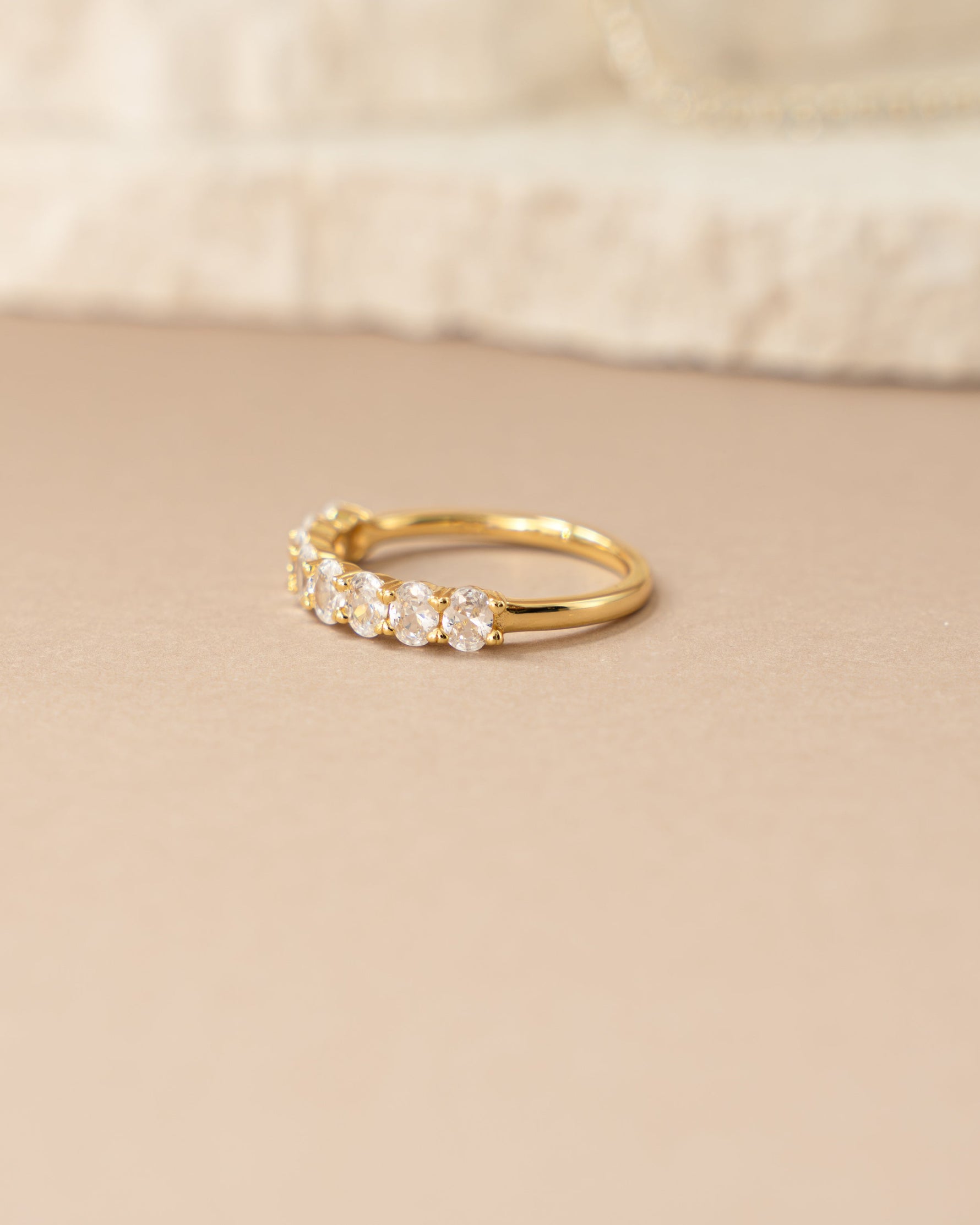 Side view of Sami Jewels oval diamond ring featuring a gold band and elegant design.
