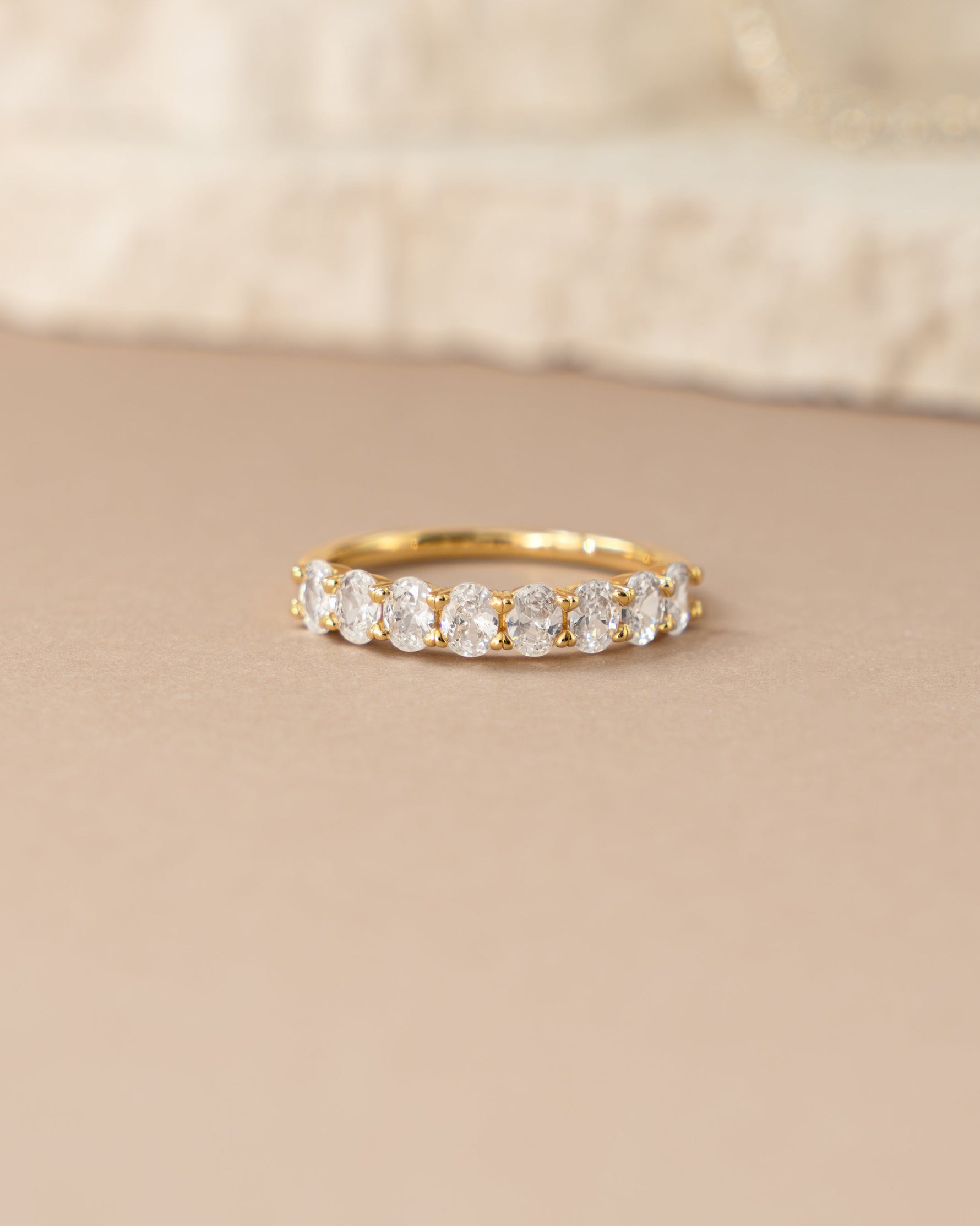 Sami Jewels oval diamond ring with gold band and detailed stone accents, showcasing elegant jewelry design.