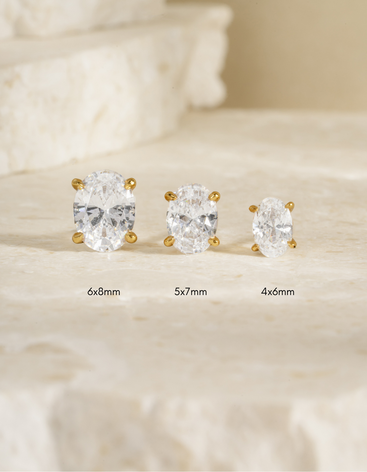 Oval stud earrings in a labelled size comparison showing 4x6mm, 5x7mm, and 6x8mm.