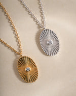 Gold and sterling silver oval medallion necklace from Sami Jewels, front view showcasing intricate design details.