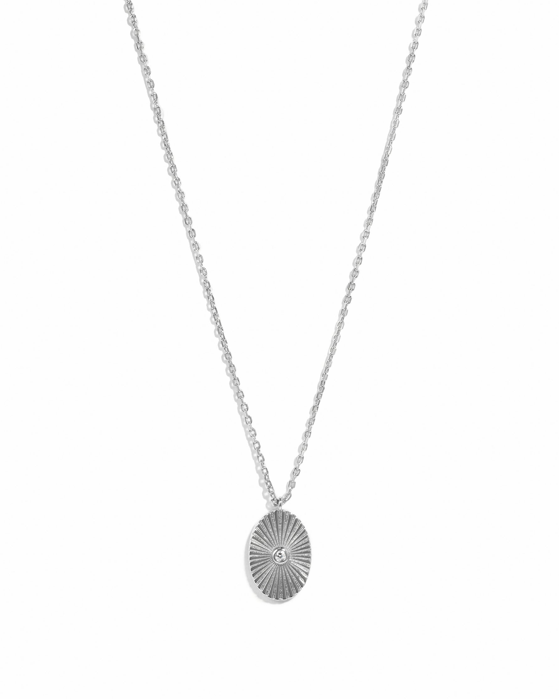 Sterling silver oval medallion necklace by Sami Jewels displayed on a white background.