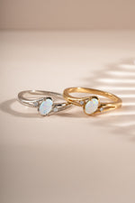 Small oval opal ring by Sami Jewels featuring a gold and sterling silver band with a vibrant oval opal gemstone.