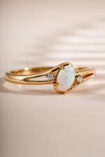 Close-up of a Sami Jewels small oval opal ring featuring a vibrant oval opal stone set in gold.